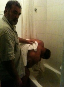 Andre desperately trying to plug 2 open water supplies whilst Rene runs out of towels to shield his body from the eyes of the local plumbing society